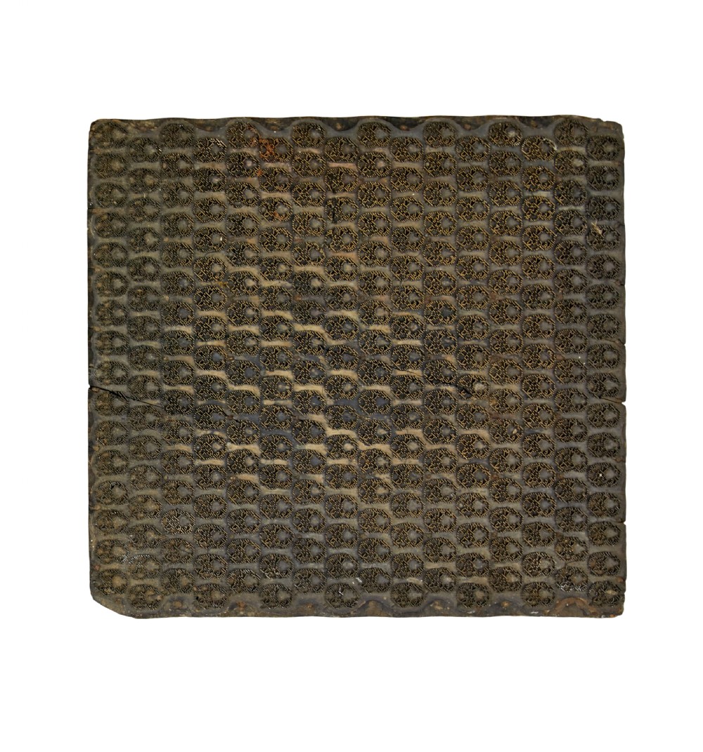 A collection of ten square and rectangular hand-carved wooden textile printing blocks featuring intricate brass wire and pin patterns. View III
