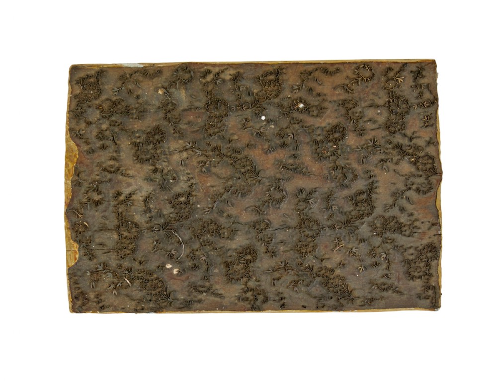 A collection of ten square and rectangular hand-carved wooden textile printing blocks featuring intricate brass wire and pin patterns. View VI