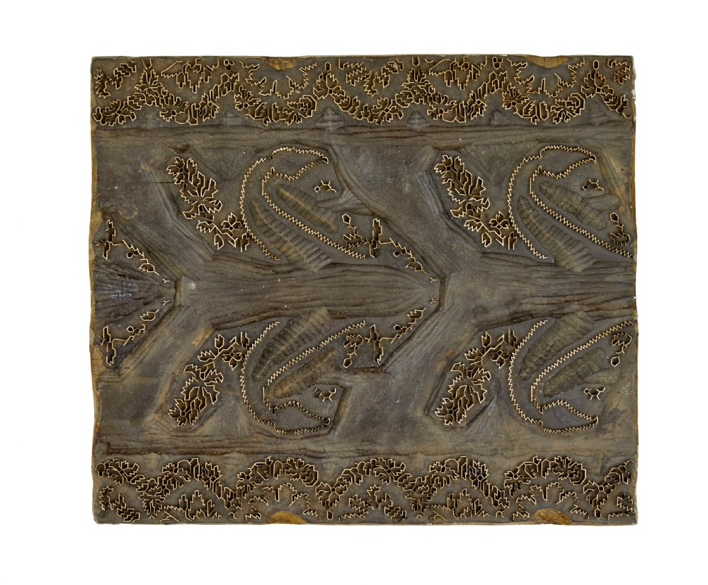 A collection of ten square and rectangular hand-carved wooden textile printing blocks featuring intricate brass wire and pin patterns. View VII