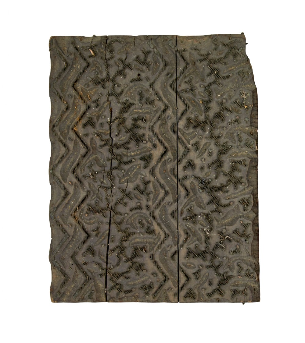 A collection of ten square and rectangular hand-carved wooden textile printing blocks featuring intricate brass wire and pin patterns. View IX