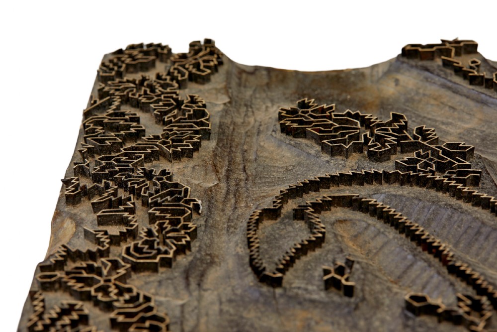 A collection of ten square and rectangular hand-carved wooden textile printing blocks featuring intricate brass wire and pin patterns. View XX