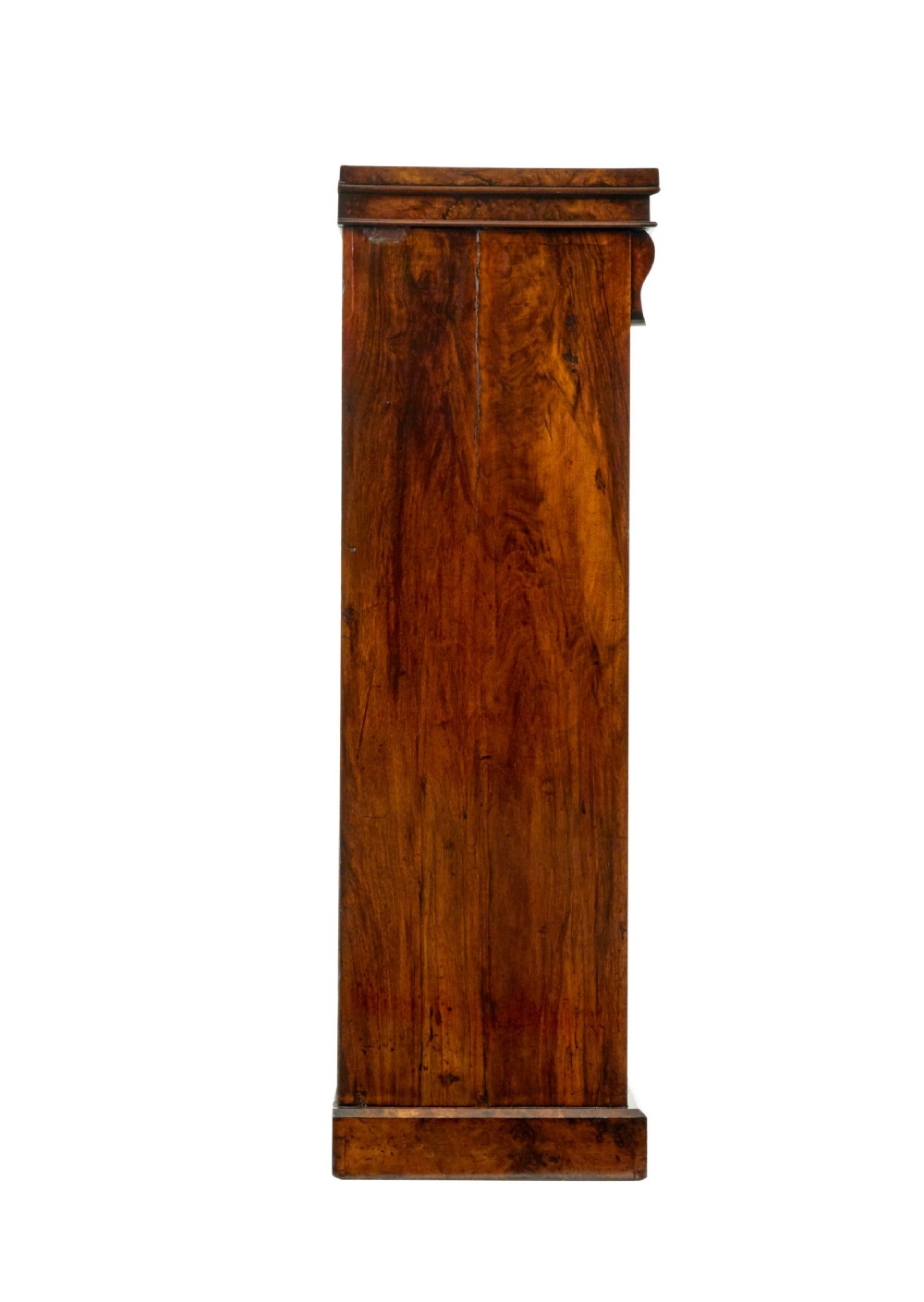 A tall, narrow Victorian burr walnut Wellington chest featuring seven graduated drawers with turned knob handles, decorative scroll brackets, and a locking side pilaster set upon a plinth base. View VII