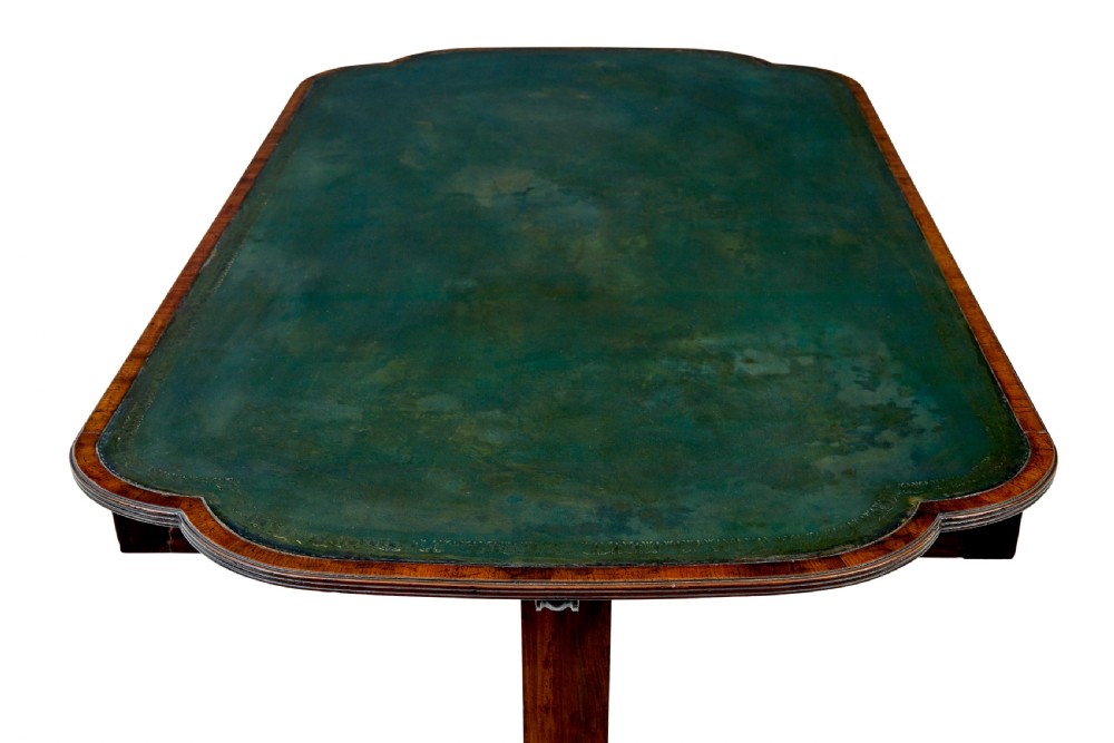 An early Victorian mahogany writing table featuring a green leather top, two drawers, an arched stretcher, and legs on brass castors. View VIII