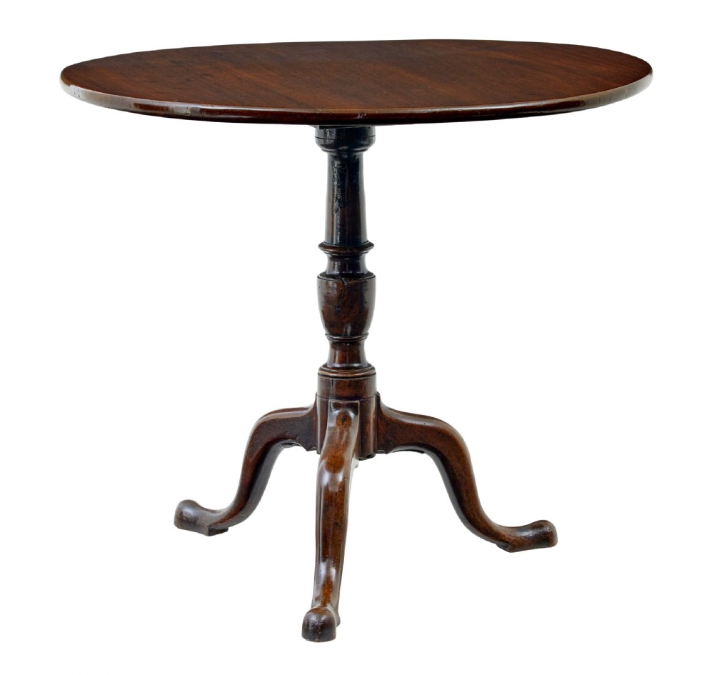 A circular dark mahogany Georgian tripod table featuring a turned central column and three cabriole legs with pad feet.