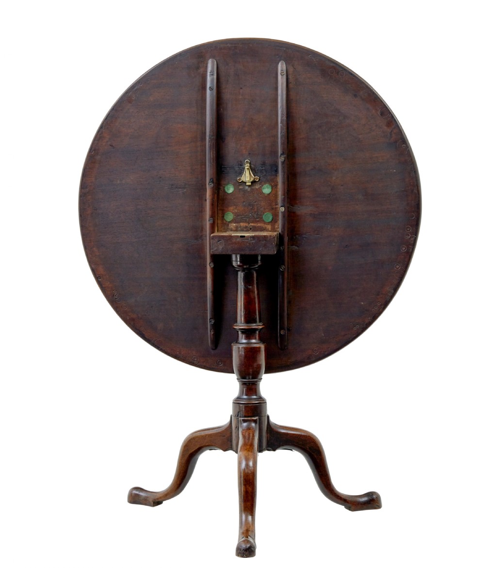A circular dark mahogany Georgian tripod table featuring a turned central column and three cabriole legs with pad feet. View V