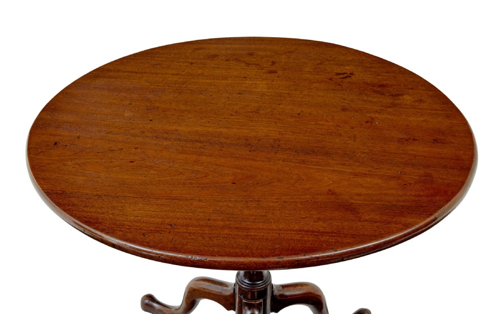 A circular dark mahogany Georgian tripod table featuring a turned central column and three cabriole legs with pad feet. View VI