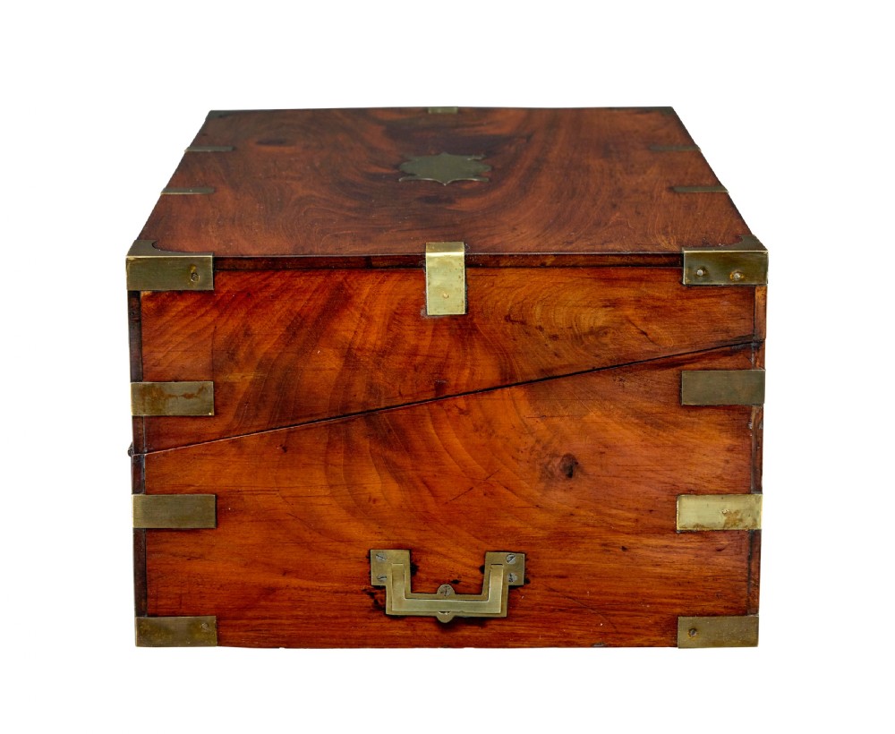 A mid-19th century mahogany campaign writing slope with protective brass-bound corners, a brass keyhole escutcheon, and flush side handles. View II