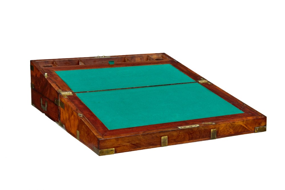 A mid-19th century mahogany campaign writing slope with protective brass-bound corners, a brass keyhole escutcheon, and flush side handles. View V