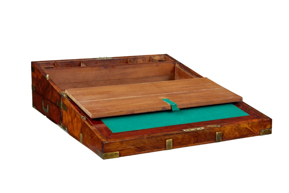 A mid-19th century mahogany campaign writing slope with protective brass-bound corners, a brass keyhole escutcheon, and flush side handles. View VI