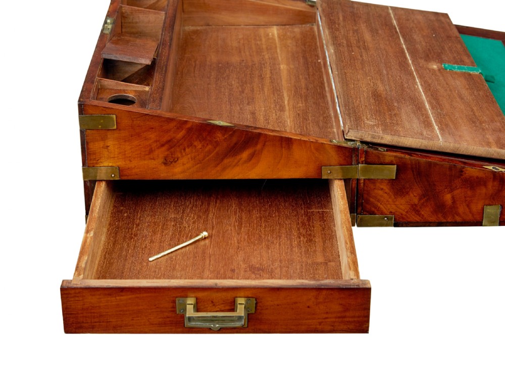 A mid-19th century mahogany campaign writing slope with protective brass-bound corners, a brass keyhole escutcheon, and flush side handles. View VIII