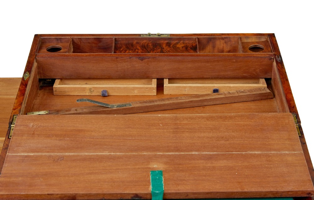 A mid-19th century mahogany campaign writing slope with protective brass-bound corners, a brass keyhole escutcheon, and flush side handles. View IX