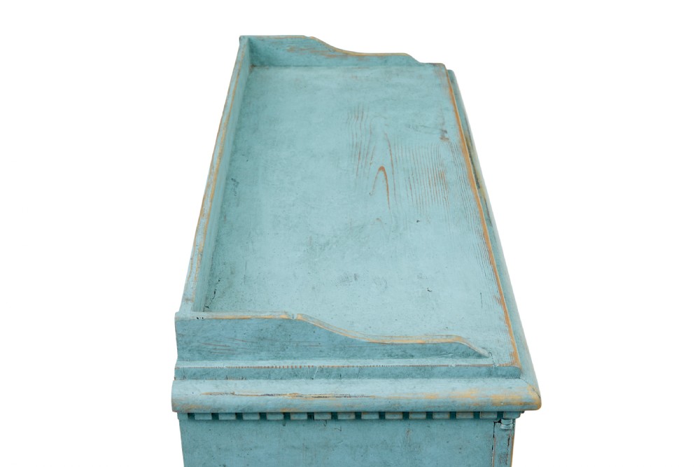 A 19th-century Scandinavian pine double-door cupboard with a distressed light blue painted finish, dentil moulding along the top, and cut-out bracket feet. View II