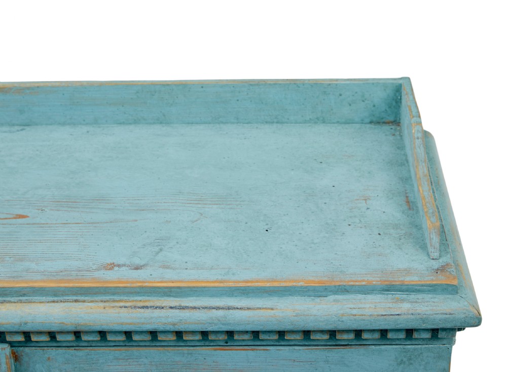 A 19th-century Scandinavian pine double-door cupboard with a distressed light blue painted finish, dentil moulding along the top, and cut-out bracket feet. View III