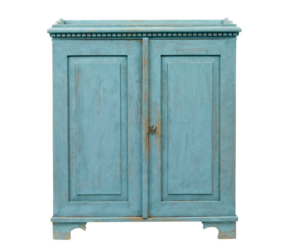 A 19th-century Scandinavian pine double-door cupboard with a distressed light blue painted finish, dentil moulding along the top, and cut-out bracket feet. View IV