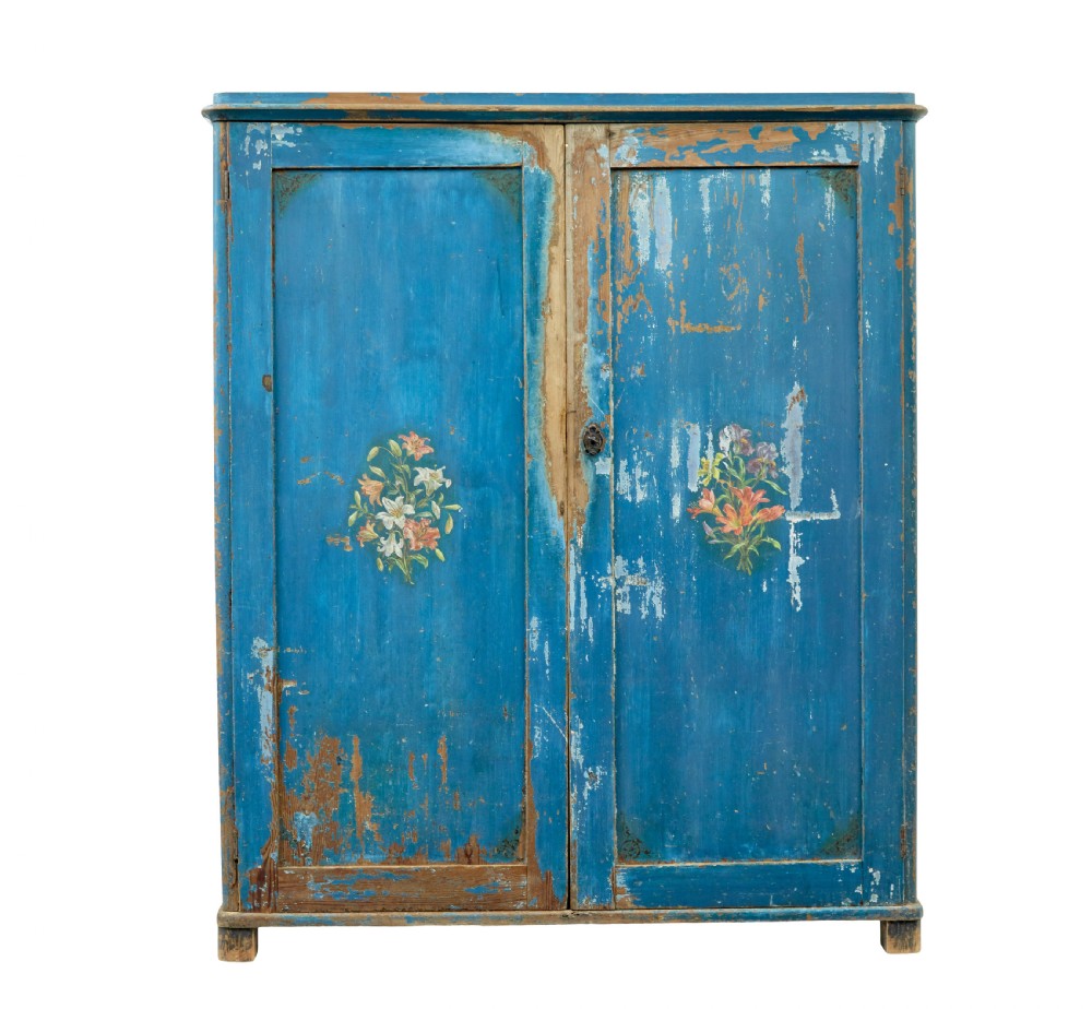 A mid-19th-century Scandinavian pine cupboard featuring distressed blue paint, two panelled doors with painted floral motifs, and short block feet. View II