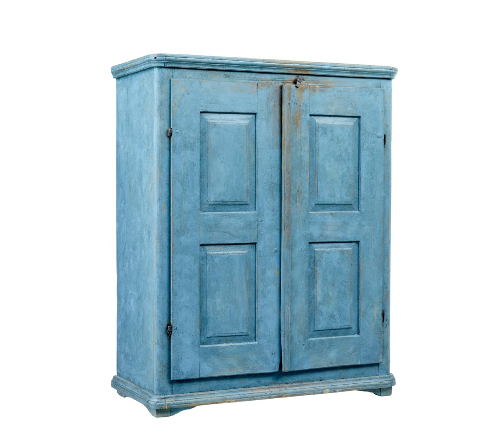 A 19th-century Swedish pine cupboard featuring a painted light blue distressed finish, double panelled doors, and top iron latch.