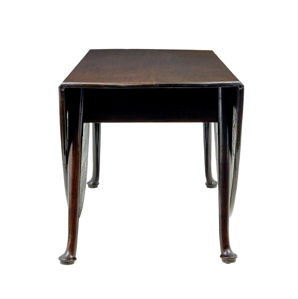 An early nineteenth-century Georgian dark mahogany drop-leaf dining table shown with both flaps lowered and tapered legs visible. View III
