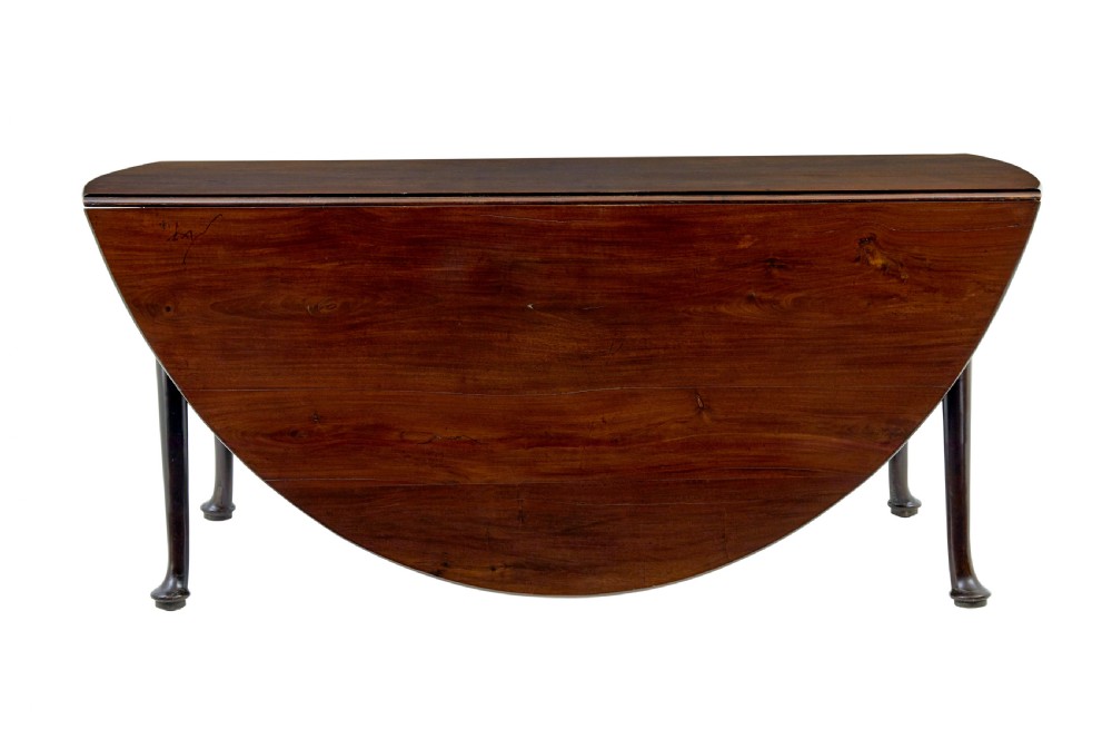 An early nineteenth-century Georgian dark mahogany drop-leaf dining table shown with both flaps lowered and tapered legs visible. View IV