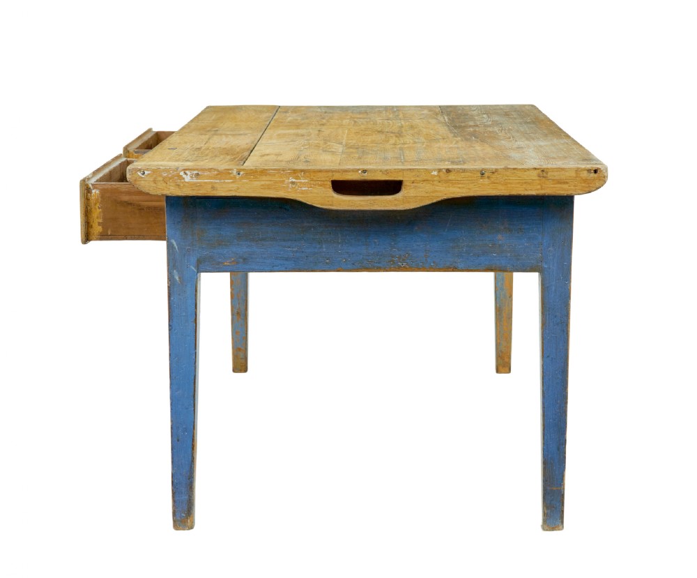 A 19th-century Scandinavian bakers table featuring a distressed blue painted base, two front drawers with brass drop handles, and an unpainted pine top with raised side lips. View V