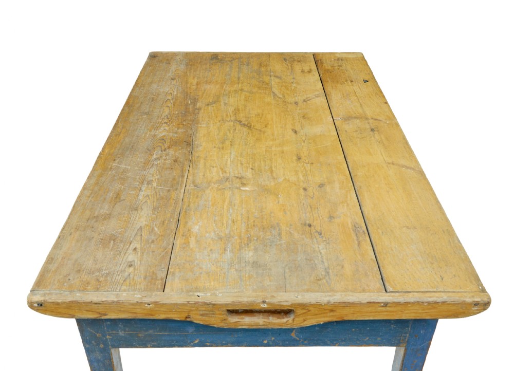 A 19th-century Scandinavian bakers table featuring a distressed blue painted base, two front drawers with brass drop handles, and an unpainted pine top with raised side lips. View VIII