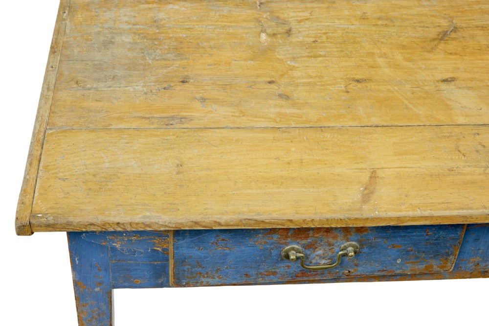 A 19th-century Scandinavian bakers table featuring a distressed blue painted base, two front drawers with brass drop handles, and an unpainted pine top with raised side lips. View X