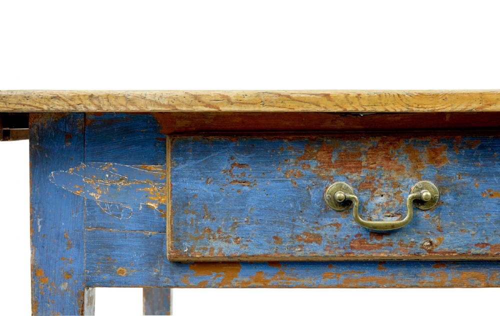 A 19th-century Scandinavian bakers table featuring a distressed blue painted base, two front drawers with brass drop handles, and an unpainted pine top with raised side lips. View XI