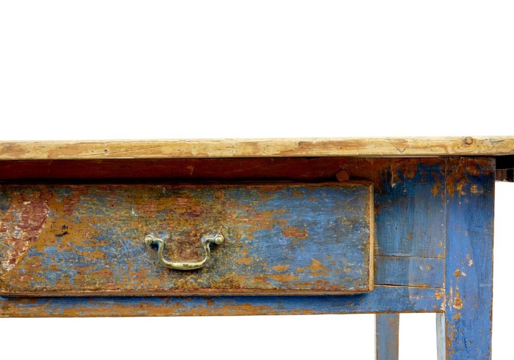 A 19th-century Scandinavian bakers table featuring a distressed blue painted base, two front drawers with brass drop handles, and an unpainted pine top with raised side lips. View XII
