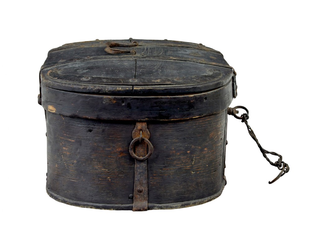 An oval 19th-century Swedish black painted wooden box featuring hand-forged iron straps, side carrying rings, and a key inserted into the central escutcheon. View IV
