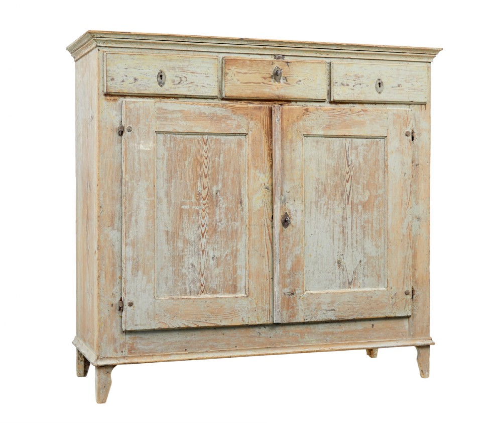 A nineteenth-century Swedish pine cabinet featuring a scraped pale blue painted finish, three top drawers, two panelled cupboard doors, and iron escutcheons.