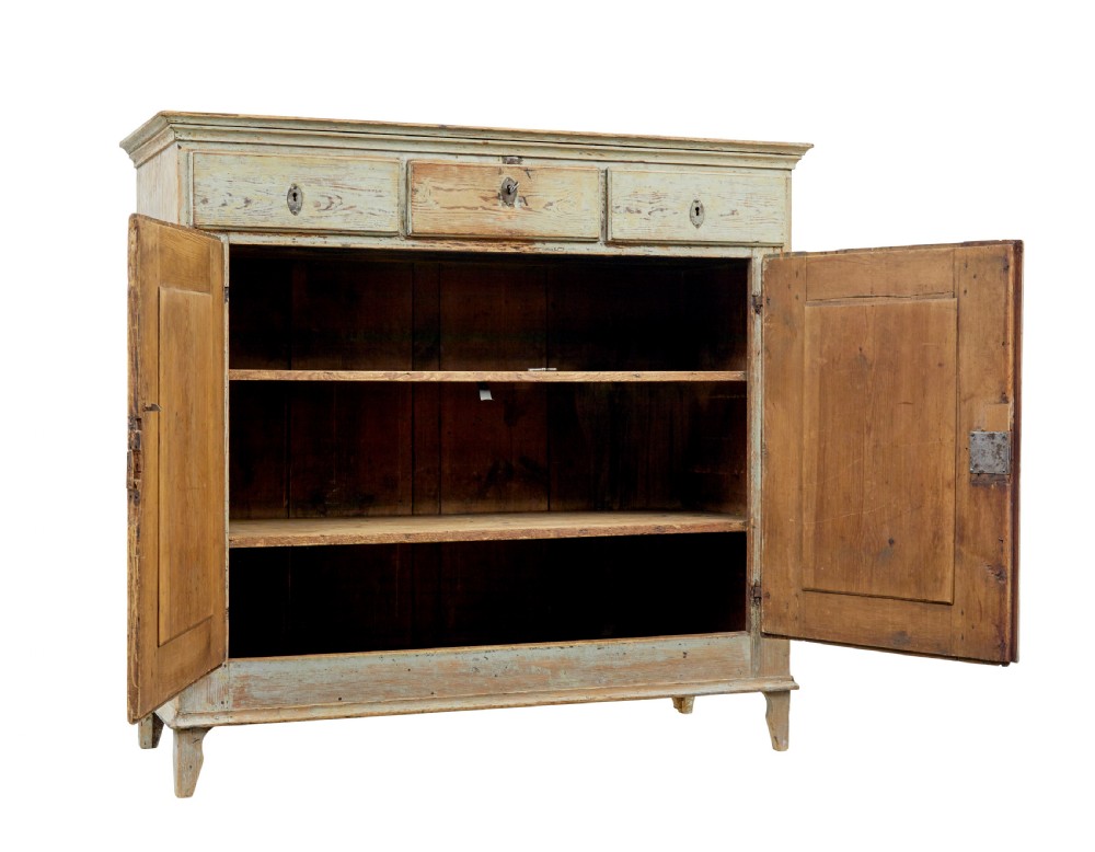 A nineteenth-century Swedish pine cabinet featuring a scraped pale blue painted finish, three top drawers, two panelled cupboard doors, and iron escutcheons. View II