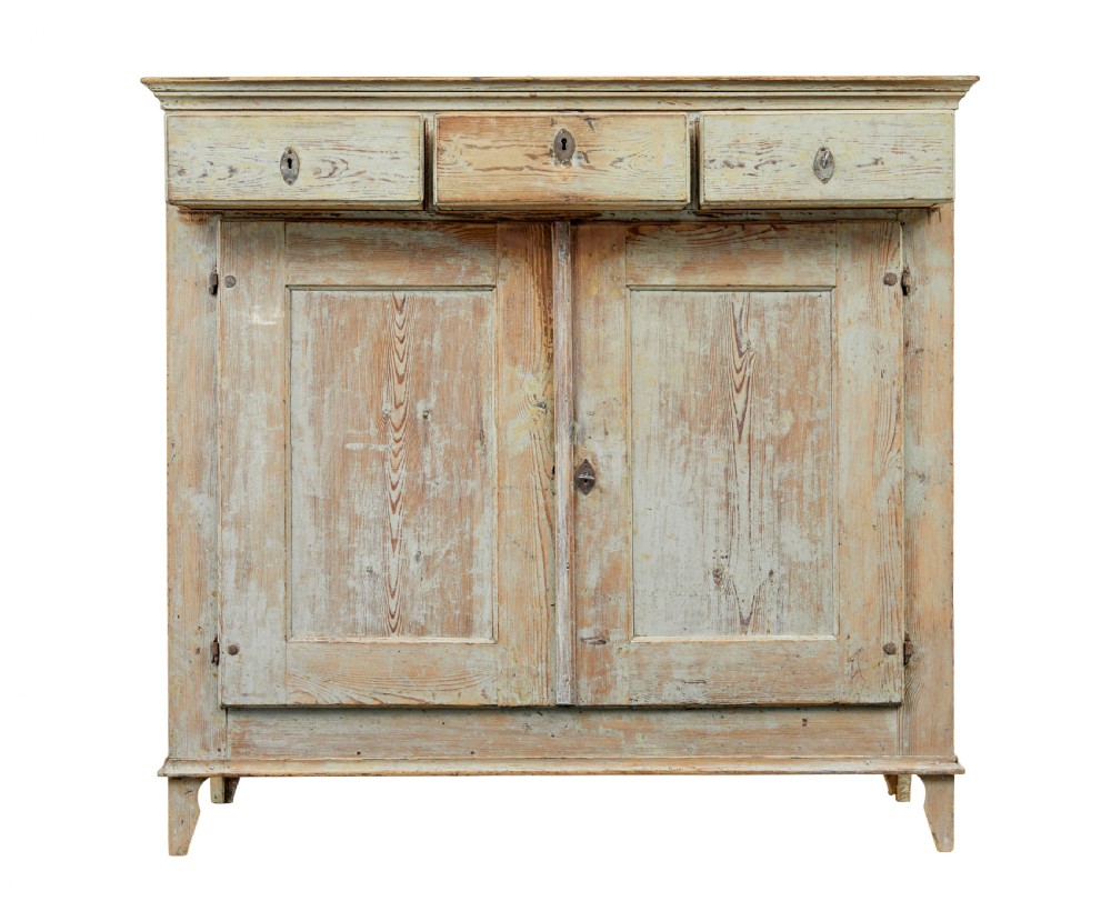 A nineteenth-century Swedish pine cabinet featuring a scraped pale blue painted finish, three top drawers, two panelled cupboard doors, and iron escutcheons. View IV
