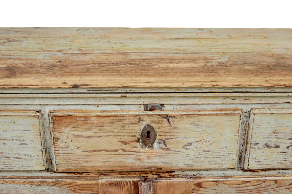A nineteenth-century Swedish pine cabinet featuring a scraped pale blue painted finish, three top drawers, two panelled cupboard doors, and iron escutcheons. View X
