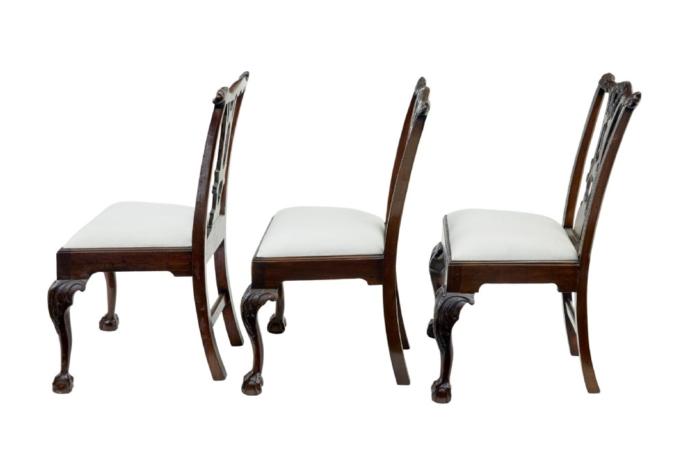 A set of mahogany Chippendale style dining chairs featuring carved back splats, cabriole legs ending in ball and claw feet, and light-coloured upholstered drop-in seats. View II