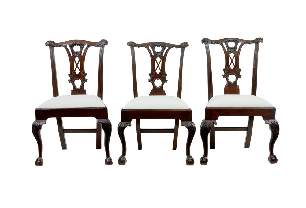 A set of mahogany Chippendale style dining chairs featuring carved back splats, cabriole legs ending in ball and claw feet, and light-coloured upholstered drop-in seats. View IV