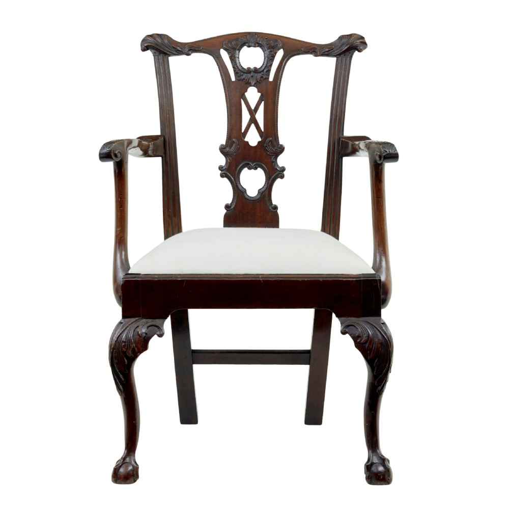 A set of mahogany Chippendale style dining chairs featuring carved back splats, cabriole legs ending in ball and claw feet, and light-coloured upholstered drop-in seats. View V