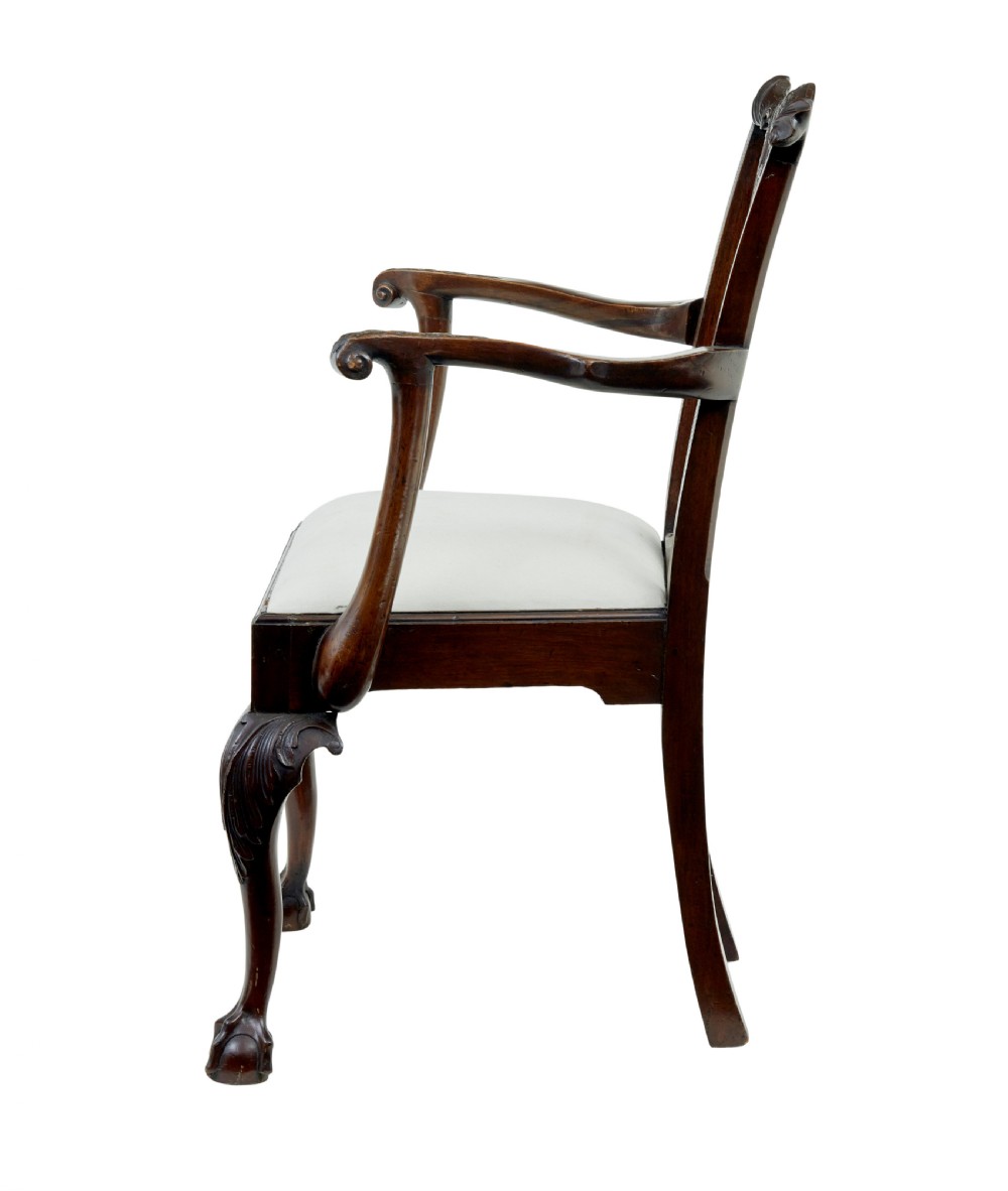 A set of mahogany Chippendale style dining chairs featuring carved back splats, cabriole legs ending in ball and claw feet, and light-coloured upholstered drop-in seats. View VI