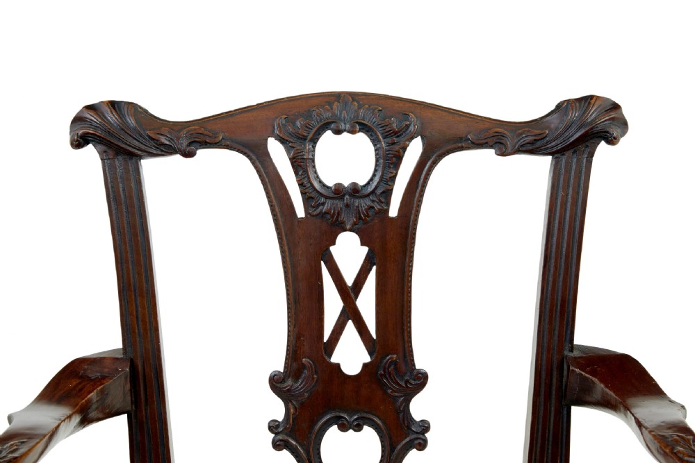 A set of mahogany Chippendale style dining chairs featuring carved back splats, cabriole legs ending in ball and claw feet, and light-coloured upholstered drop-in seats. View VII