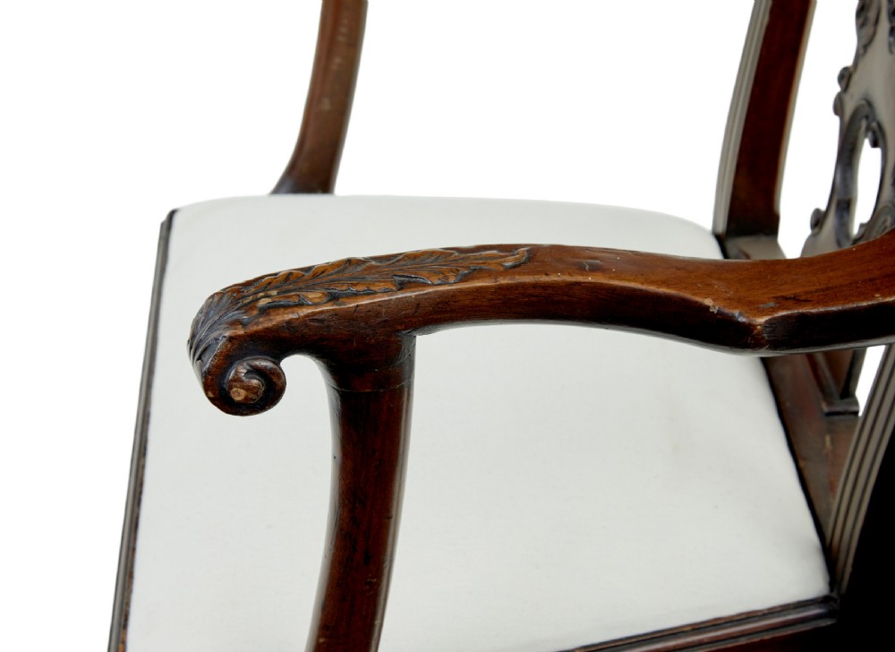 A set of mahogany Chippendale style dining chairs featuring carved back splats, cabriole legs ending in ball and claw feet, and light-coloured upholstered drop-in seats. View VIII