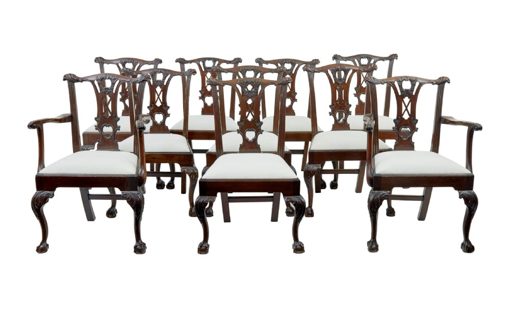 A set of mahogany Chippendale style dining chairs featuring carved back splats, cabriole legs ending in ball and claw feet, and light-coloured upholstered drop-in seats. View XI