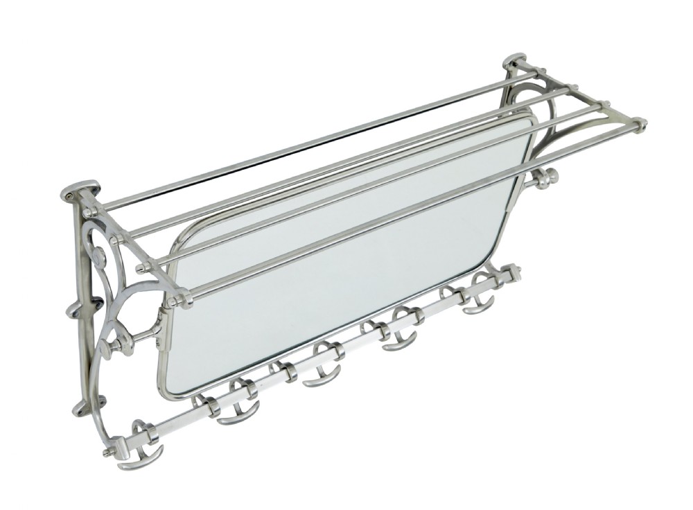 An early 20th-century chromed metal wall rack featuring a central tilting rectangular mirror, a top tubular shelf, and five lower double coat hooks. View V