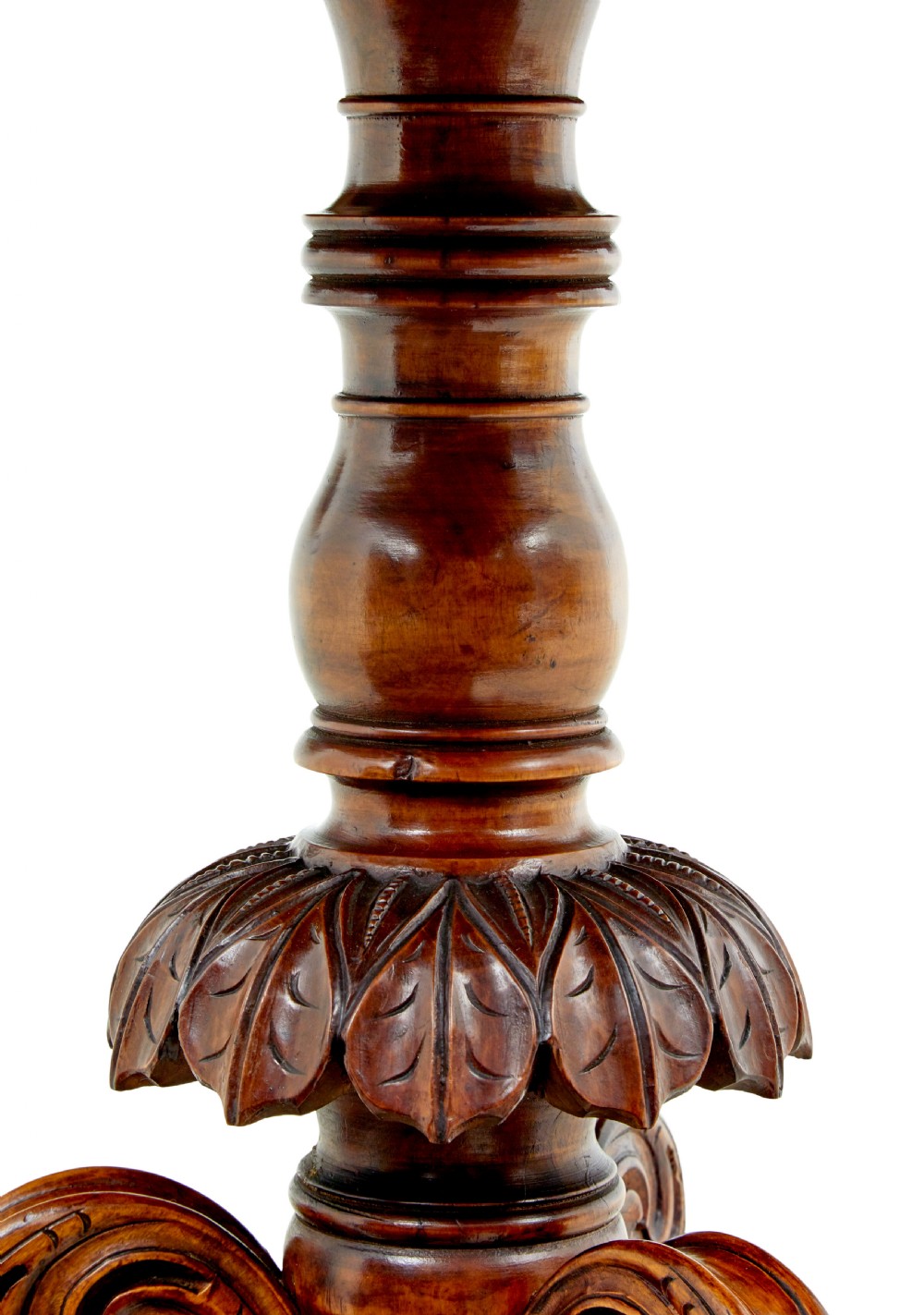 A 19th-century oval wood centre table featuring a figured veneer top, a turned central stem with acanthus leaf carving, and three scroll tripod legs. View VII