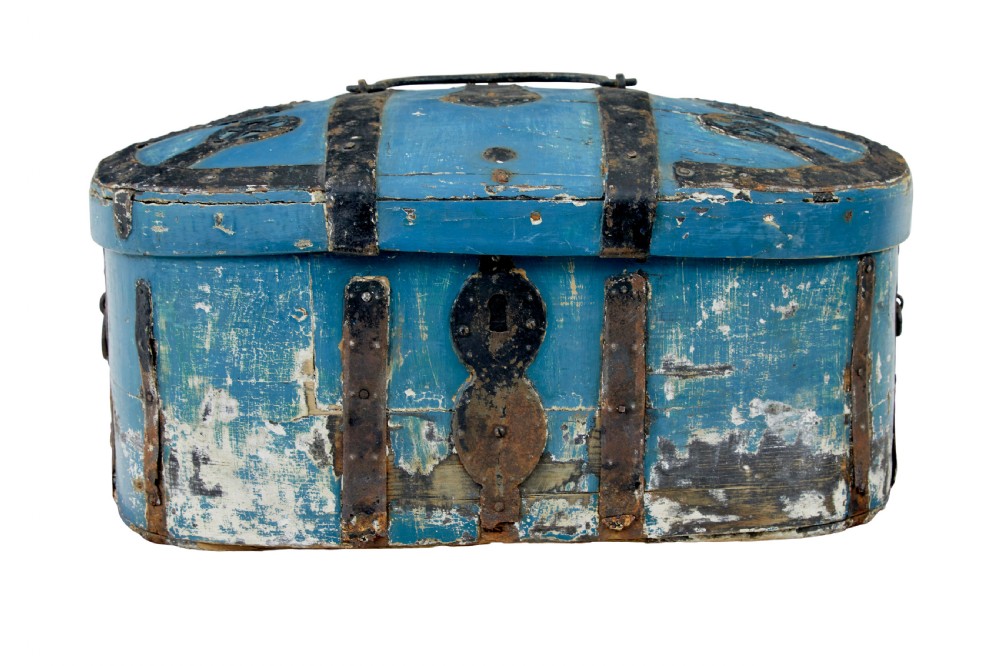 A 19th-century oval wooden strong box featuring distressed blue paint, hand-forged black iron straps, and a central keyhole escutcheon.
