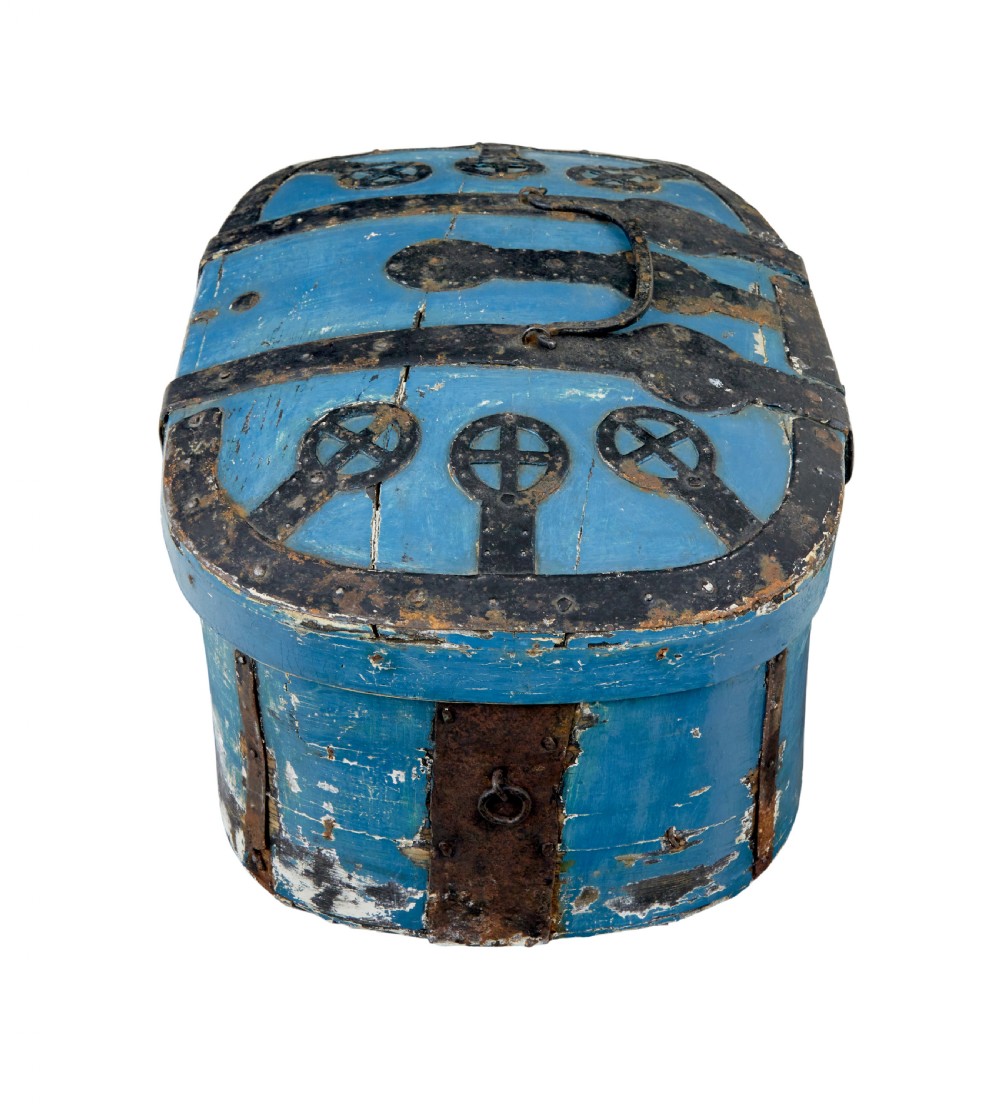A 19th-century oval wooden strong box featuring distressed blue paint, hand-forged black iron straps, and a central keyhole escutcheon. View IV