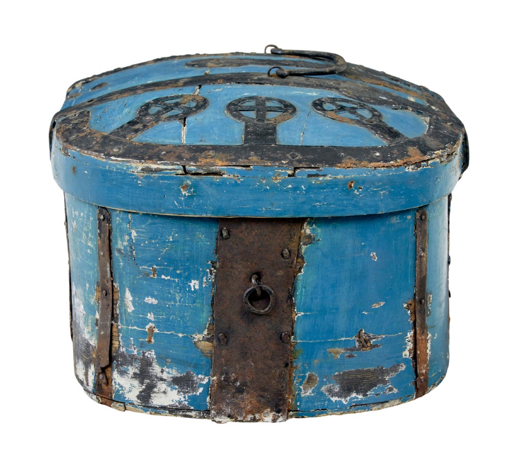 A 19th-century oval wooden strong box featuring distressed blue paint, hand-forged black iron straps, and a central keyhole escutcheon. View V