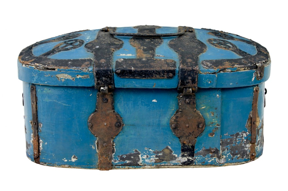 A 19th-century oval wooden strong box featuring distressed blue paint, hand-forged black iron straps, and a central keyhole escutcheon. View VI
