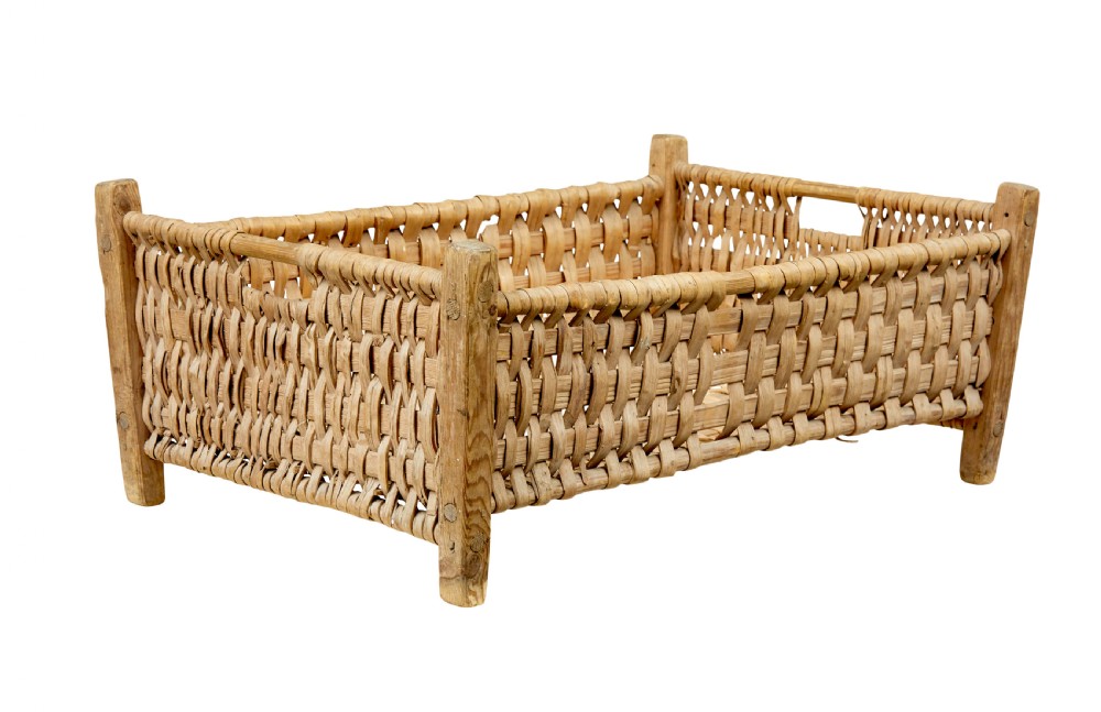 A rectangular hand-woven pine splint basket featuring four raised wooden corner posts and woven timber strips.