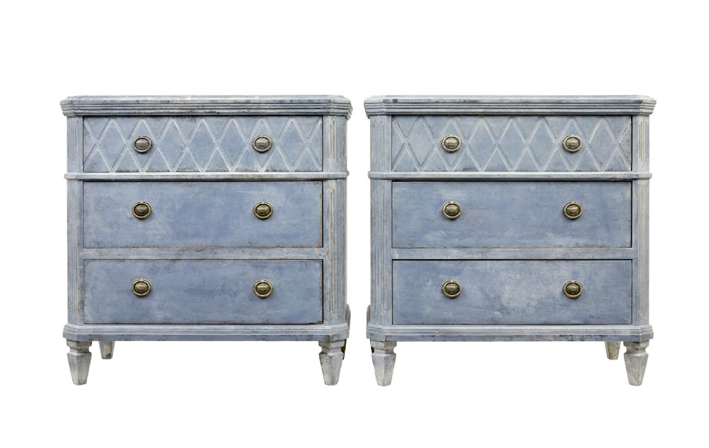 A pair of 19th-century Swedish Gustavian influenced three-drawer chests of drawers with a muted grey-blue painted finish and brass ring handles. View II