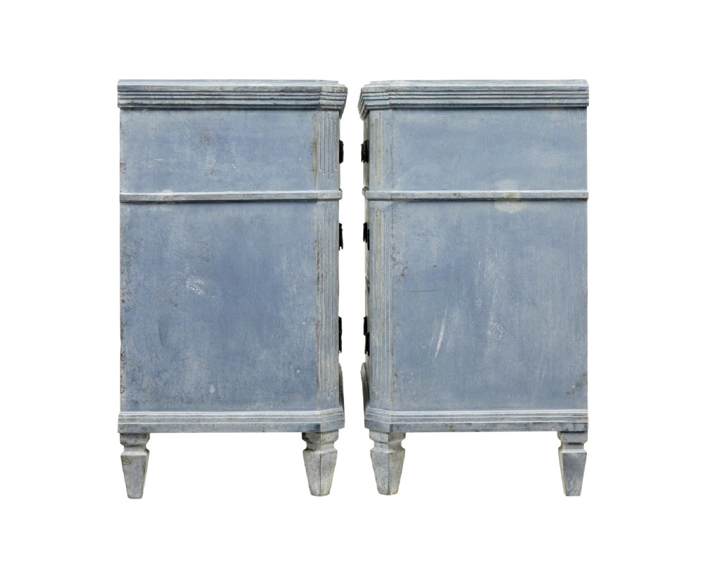 A pair of 19th-century Swedish Gustavian influenced three-drawer chests of drawers with a muted grey-blue painted finish and brass ring handles. View V