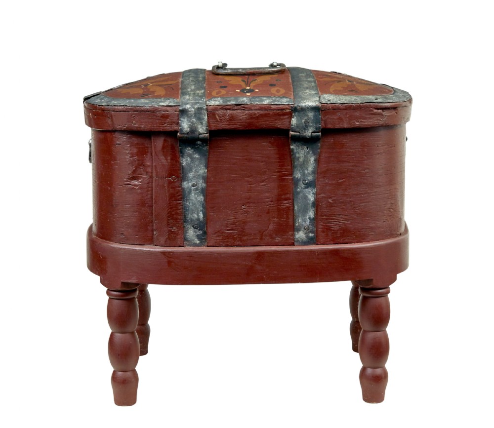 A Swedish folk art painted wooden coffer on turned legs, decorated with red paint, floral motifs, iron straps, and a painted 1827 date. View V