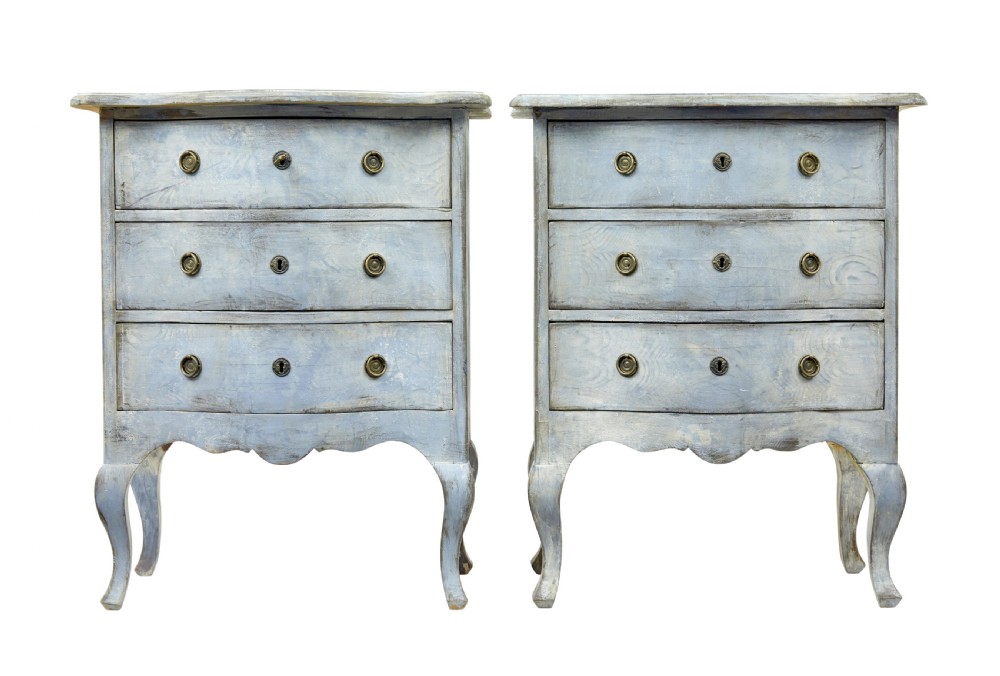 A pair of 19th-century Swedish three-drawer commodes featuring distressed pale blue painted finishes, cabriole legs, and brass hardware.